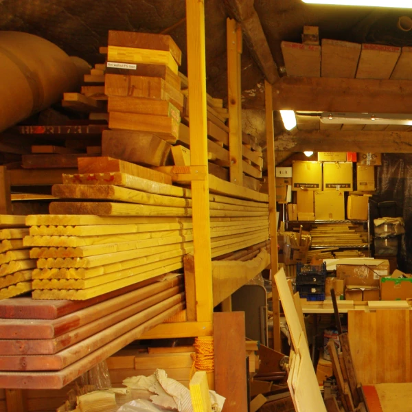 Stacks of cut wooden planks stacked on shelves in my workshop.